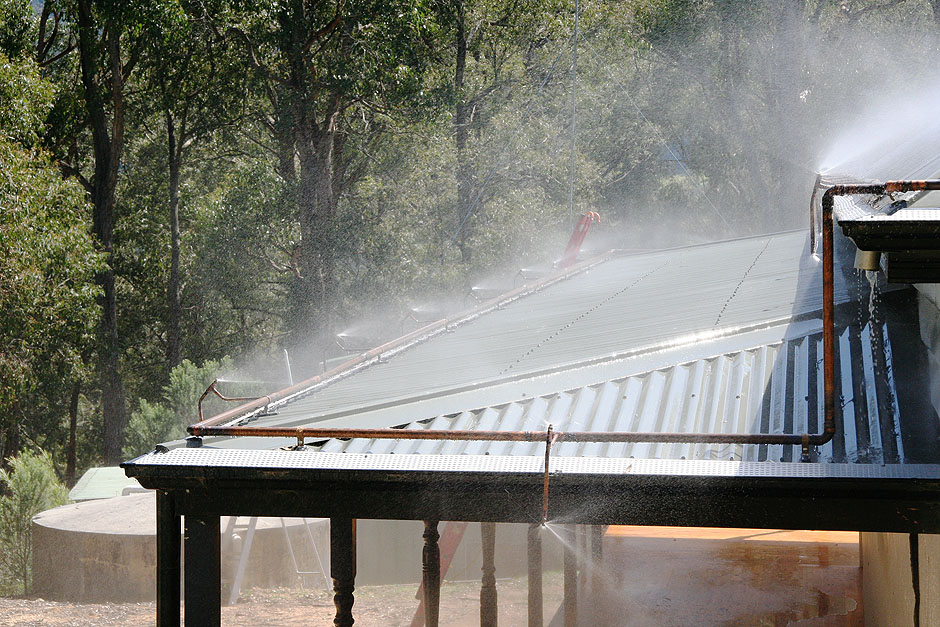 sprinkler systems control roof system water bushfire blaze fixed fire gutter building houses installation pitch prevention supply pipe remove valley